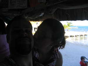 Relaxing at the beach bar.  Thatched roof, sand floor.  "No shirt, no shoes, no problem"